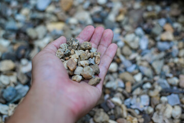 Small fractions of stone and gravels in hand.