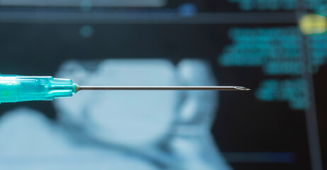 Close-up of injection needle with x-ray film in the background. Medical expert, doctor, hospital operating room.