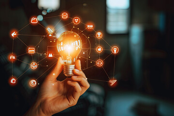 A hand holds a light bulb with business digital marketing innovation technology icons on a network in the background