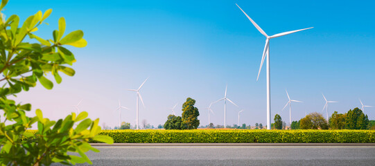 Clean roads and wind energy: renewable energy. EV Charger station. Environmentally responsible logistics industry with clean energy. Wind turbines generate electricity in vast fields. panoramic image 