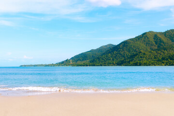 Fototapeta na wymiar Beautiful beach in Thailand and Majestic Mountains island in the background.