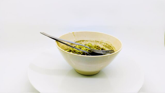 spinning or display rotating of a bowl of rawon flavored instant noodles with black sauce isolated on white background
