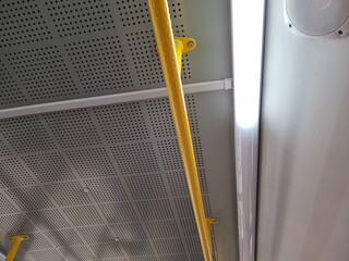 Yellow handrail on a bus