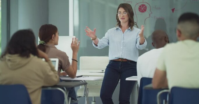 Students, question and discussion to lecturer in classroom, biology lesson and anatomy in university. People, diversity or college in learning or education, teaching or answer to knowledge on campus