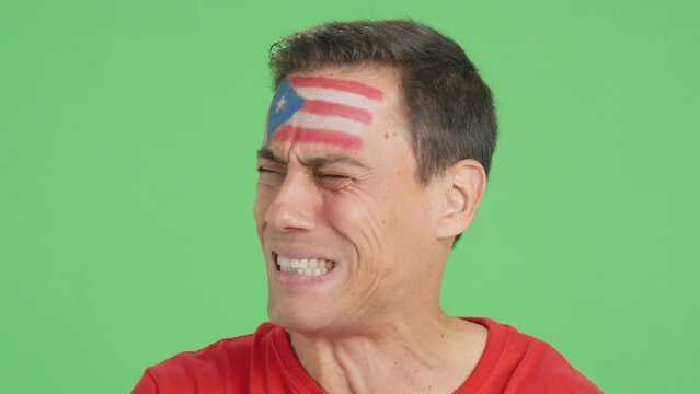 Very nervous man supporting puerto rican team during a difficult match.