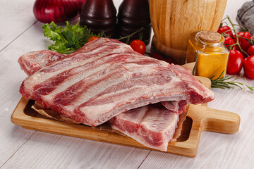 Raw pork ribs over board