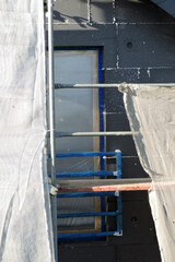 A wall of a house covered with EPS graphite polystyrene boards for thermal insulation, a window...