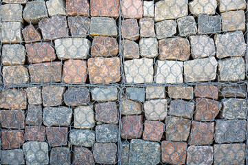 The wall protects from the erosion of rocks on the slopes.seaside.