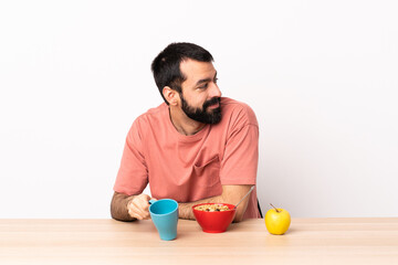 Fototapeta na wymiar Caucasian man having breakfast in a table . Portrait.