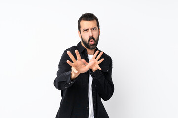 Young man with beard over isolated white background nervous stretching hands to the front