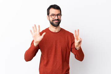 Fototapeta premium Caucasian handsome man with beard over isolated white background counting seven with fingers