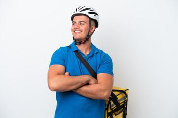 Young caucasian man with thermal backpack isolated on white background happy and smiling
