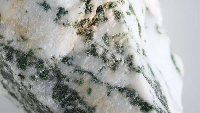 Tree Agate - form of quartz with dendritic inclusions - from India, rotating slowly against a white background.	