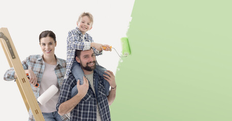 Happy family painting their new house