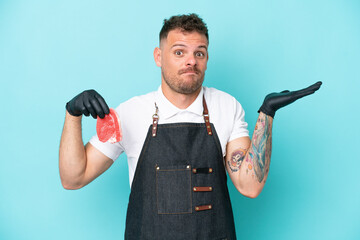 Butcher caucasian man wearing an apron and serving fresh cut meat isolated on blue background...