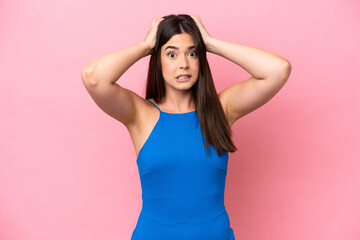 Young Brazilian woman isolated on pink background doing nervous gesture