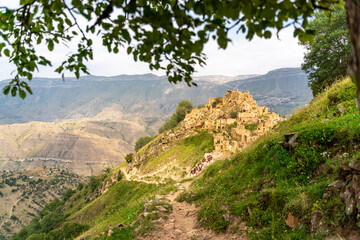 Dagestan Gamsutl. Ancient ghost town of Gamsutl old stone houses in abandoned Gamsutl mountain village in Dagestan, Abandoned etnic aul, summer landscape.