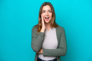 Young caucasian woman isolated on blue background with surprise and shocked facial expression