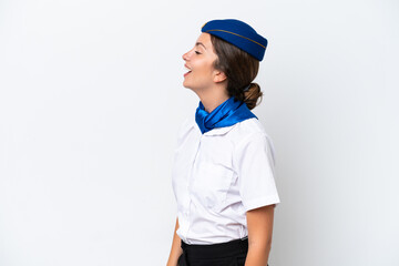 Airplane stewardess caucasian woman isolated on white background laughing in lateral position