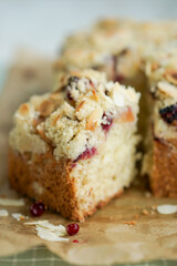 Home made coffee cake with apples with cramb topping and almond slices on crafte background close up selective focus