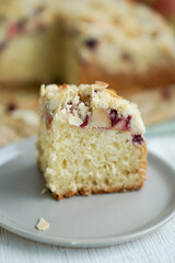 Home made coffee cake with apples with cramb topping and almond slices on crafte background close up selective focus