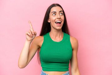Young caucasian woman isolated on pink background intending to realizes the solution while lifting a finger up - obrazy, fototapety, plakaty