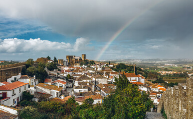 Cityscape with the rainbow as it seen from castle walls in UNESCO World heritage town of Óbidos, Leiria, Portugal.