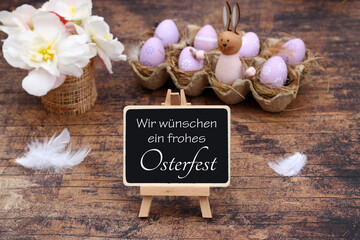 Osterdekoration mit Blumen, Ostereiern und dem Text wir wünschen ein frohes Osterfest auf einer...