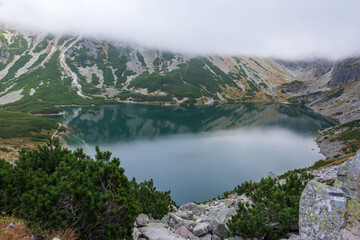 View down towards the clear, reflective water of Czarny Staw Gasienicowy Lake in Poland's Tatra...