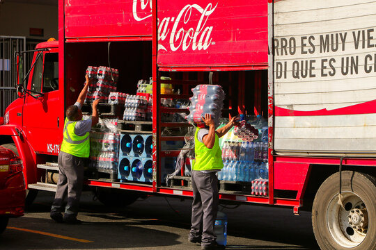 San Cristobal de las Casas, Mexico - December 29, 2018: Loaders unload bottles of Coca Cola from a truck