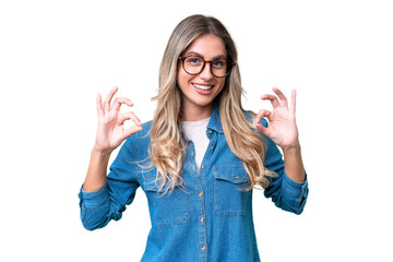 Young Uruguayan woman over isolated background showing ok sign with two hands