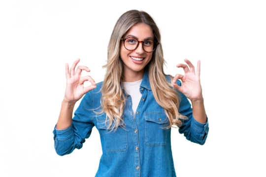 Young Uruguayan woman over isolated background showing ok sign with two hands
