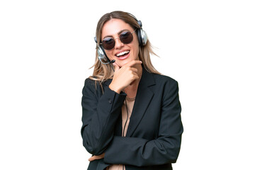 Telemarketer pretty Uruguayan woman working with a headset over isolated background with glasses...