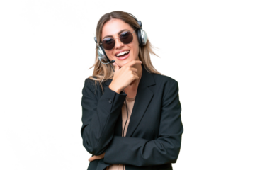 Telemarketer pretty Uruguayan woman working with a headset over isolated background with glasses and smiling