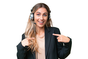 Telemarketer pretty Uruguayan woman working with a headset over isolated background with surprise...