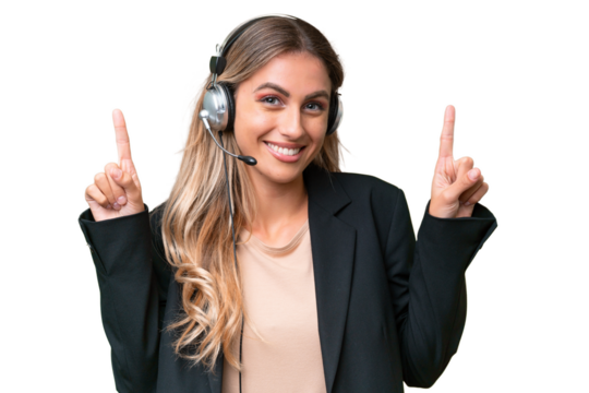 Telemarketer pretty Uruguayan woman working with a headset over isolated background pointing up a great idea