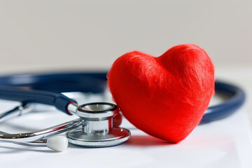 Red heart and stethoscope on white, heart: health care concept