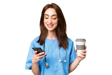 Young nurse woman over isolated chroma key background holding coffee to take away and a mobile