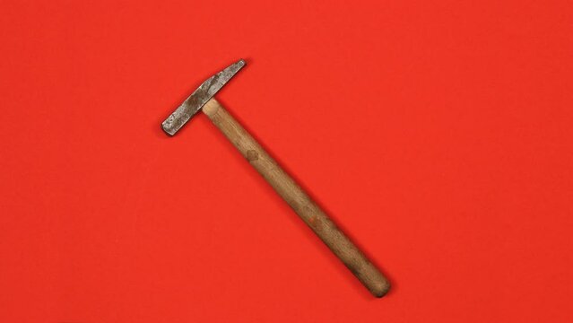Hammer in motion. Seamless loop, workers tools concept. Top view, 4K stop motion animation.