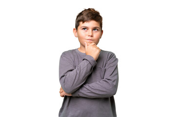 Little caucasian kid over isolated chroma key background thinking an idea while looking up
