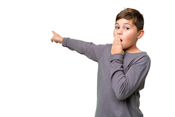 Little caucasian kid over isolated chroma key background with surprise expression while pointing...
