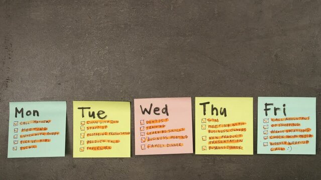 Weekly plan on colorful post it papers marked with orange highlight marker. Time passing, lot of tasks concept. 4K stop motion animation.