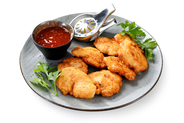 Chicken breast fried in batter or nuggets with chili sauce.  isolated on white background