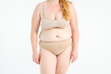 Fat woman in orange underwear on gray background, overweight female, body positive concept - 745106380