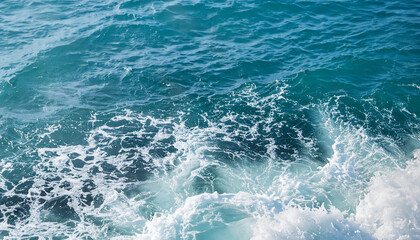 Background shot of aqua sea water surface with foam and copy space