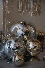 Disco balls lie in the room. Disco party