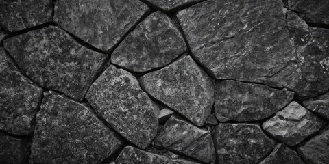 Fototapeta premium Black white stone texture. Rock surface. Close-up. Like a old rough concrete wall. Dark gray grunge background with space for design