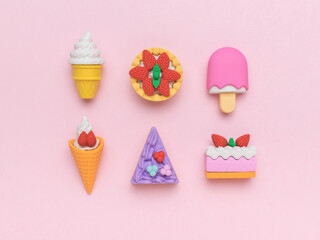 A set of sweets made of cake and ice cream on a pink background.
