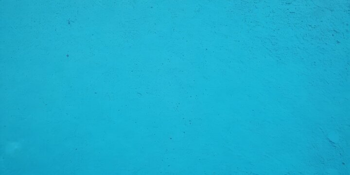 Blue light concrete texture for background in summer wallpaper. Cyan cement color sand wall