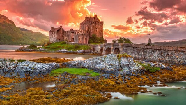 Eilean Donan Castle at sunset, Dornie, Kyle of Lochalsh in Scotland, United Kingdom. It is the most visited castle, situated on an island at the confluence of three sea lochs. TIME-LAPSE